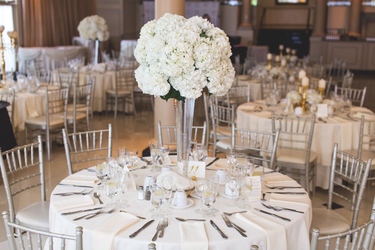 Banquet round dressed with tall white floral centrepieces