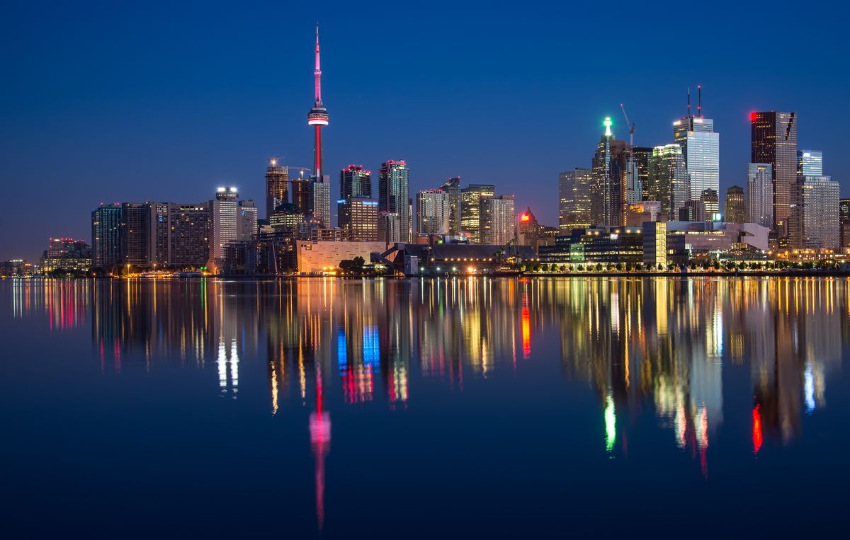 City skyline at dusk reflected in water