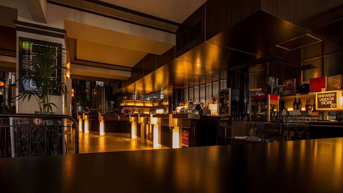 Lounge bar with warm lighting and city views