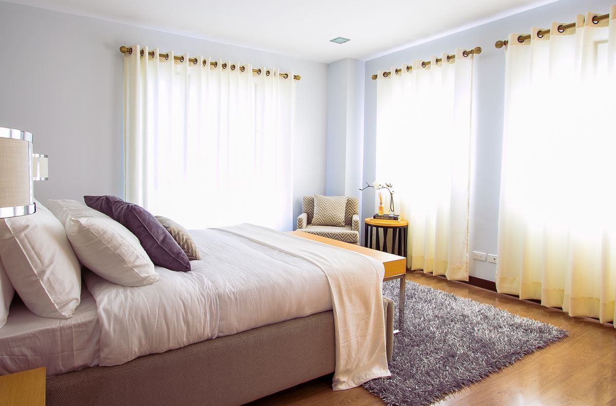 Deluxe room with a queen bed and a window overlooking the city